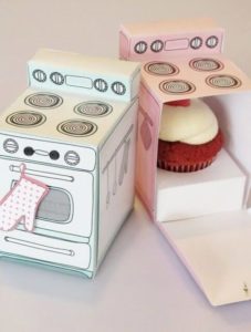 Miniature paper ovens filled with cupcake